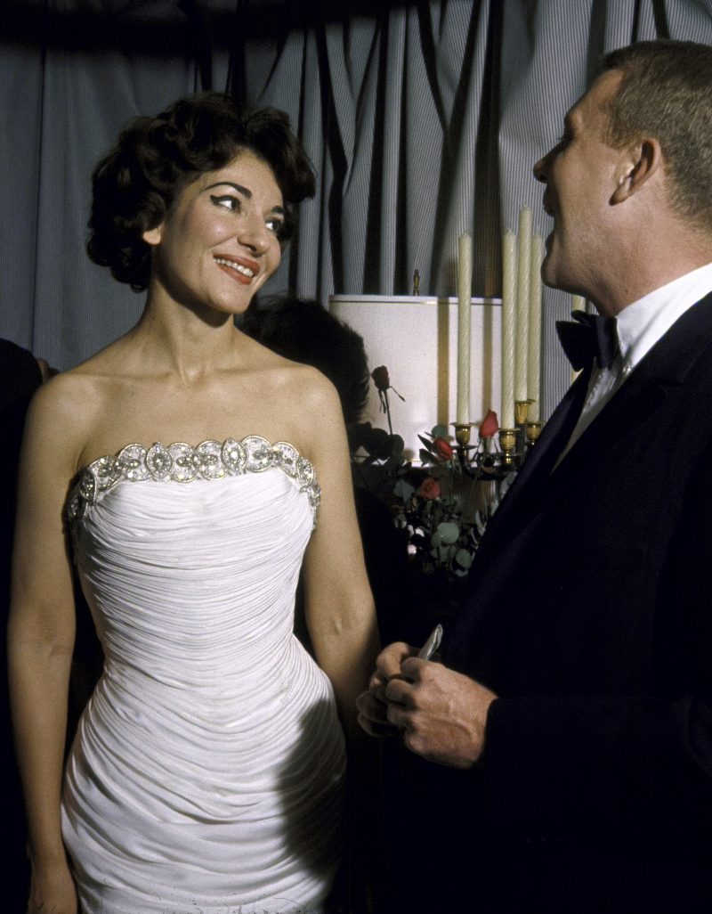 American-born Greek opera singer Maria Callas (1923 - 1977) smiles as she speaks with an admirer after her performance at the Loews Midland Theater, Kansas City, Missouri, October 28, 1959. She is dressed in a sleeveless white evening gown. (Photo by A.Y. Owen/Time & Life Pictures/Getty Images)